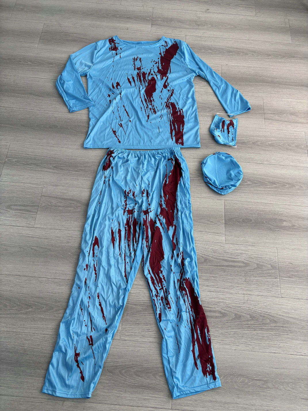 Light-blue surgeon scrubs costume with printed blood splatter, cap and mask