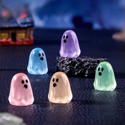 Mini glow-in-the-dark ghost figures in a row