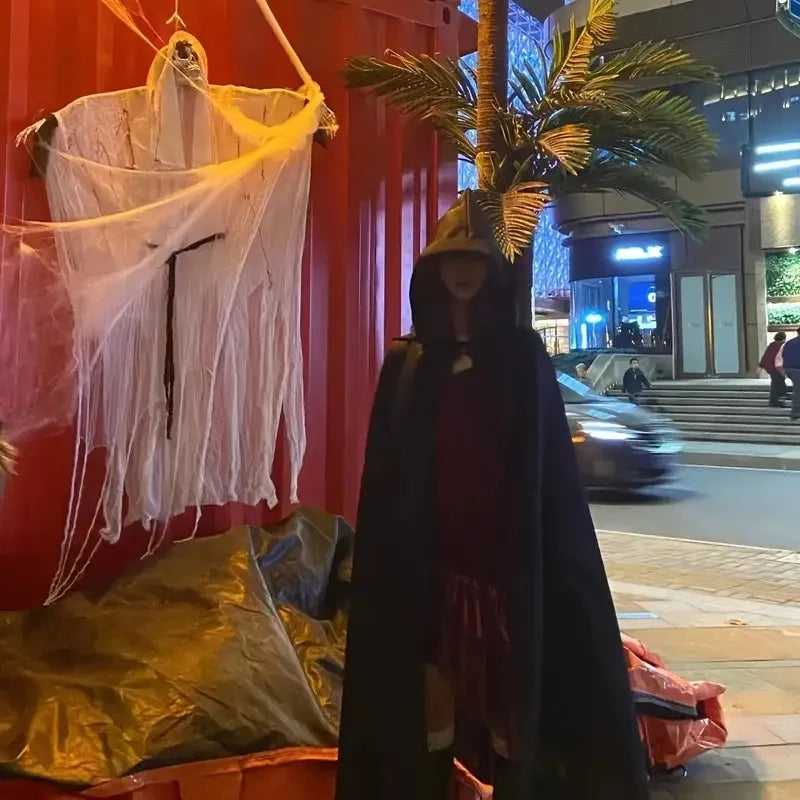 Hooded black cloak, side view