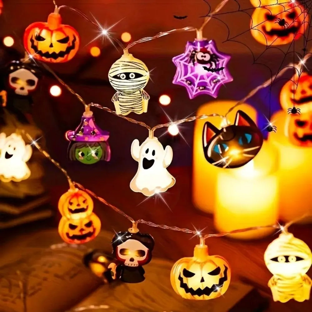 Halloween string lights with pumpkins, ghosts and skulls lit at night