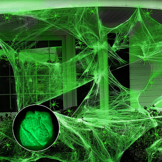 Glow-in-the-dark spider web stretched across a doorway at night