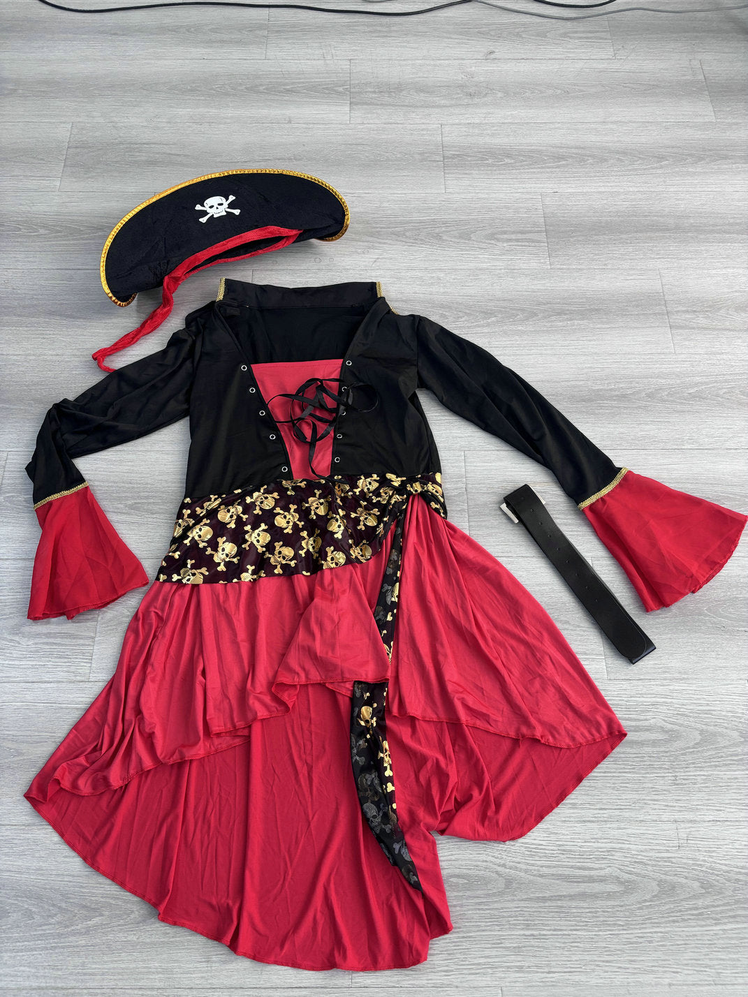 Women's pirate costume: red and black dress, skull sash, belt and tricorn hat